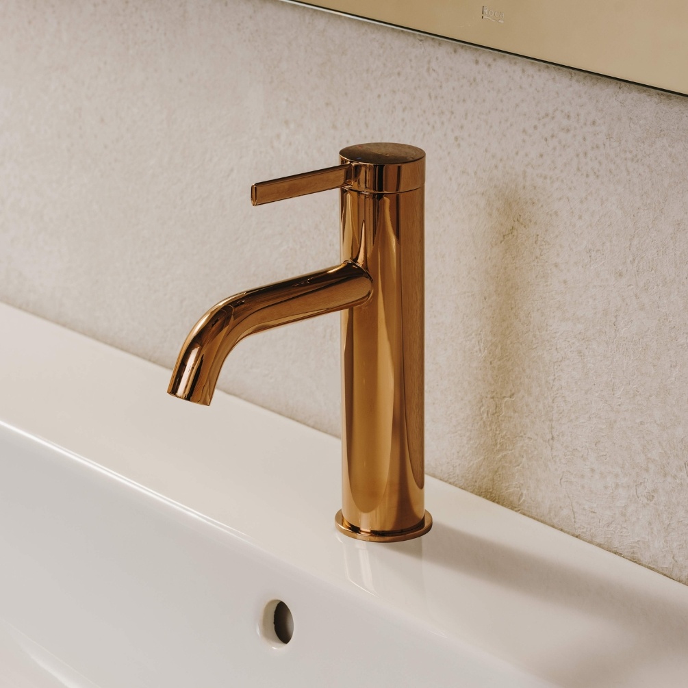 Lifestyle image of the Roca Ona Rose Gold Basin Mixer Tap with Click-Clack Waste mounted on a basin